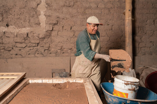 Peruvian man with plaster shovel