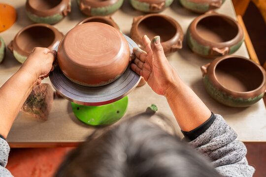Anonymous artisan painting ceramic bowl