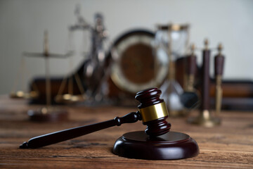 Law concept. Law symbols composition: judge’s gavel, Themis sculpture and scale on rustic wooden desk.