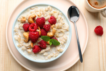 Flat lay composition with tasty oatmeal porridge on wooden table. Healthy meal