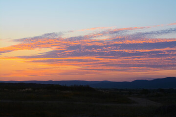 Picturesque view of landscape under beautiful evening sky with clouds at sunset