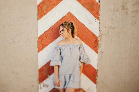 Happy woman laughing against shabby wall