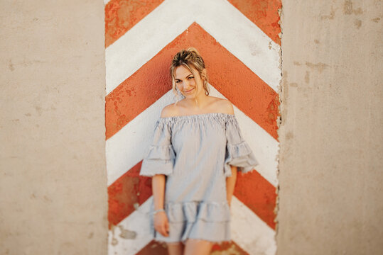 Happy woman laughing against shabby wall