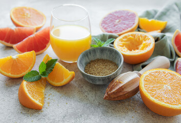 Glass of juice and citrus fruits.