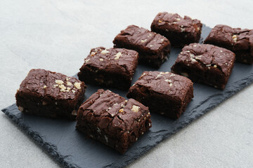 Homemade chocolate fudge brownie with almond topping, close up