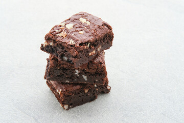 Homemade chocolate fudge brownie with almond topping, close up