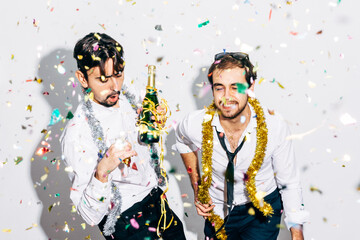 Best friends with bottle of champagne having fun during party