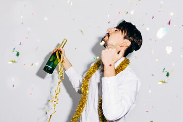 Drunk bearded man with bottle of champagne during Christmas holiday