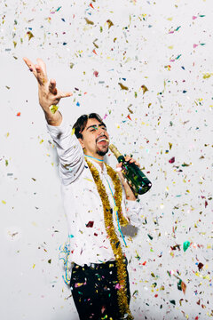 Drunk bearded man with bottle of champagne during Christmas holiday