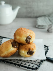 Bomboloni Donut with chocolate fillings. Blurred background and selected focus.
