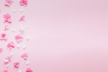 Valentine's Day background. Frame made of pink flowers, hearts on pastel pink background. Valentines day concept.