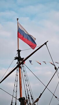 national flag of Russia is flying on the mast of the ship