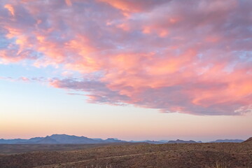 Fototapeta na wymiar Dramatic pink sunset over the grass fields in the Big Bend National Park Desert in Texas