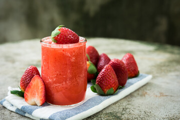  strawberry smoothie with fresh strawberry fruit on dark blackground