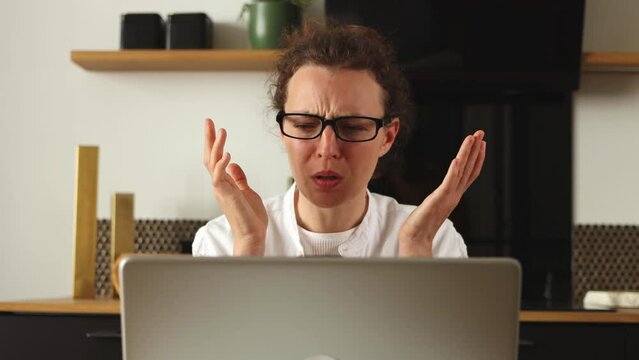 Young caucasian woman reading bad news on laptop looking desperate, feel stressed due to unsaved document, sit at home office.Recieved notice form bank about debt, important data loss, device malware