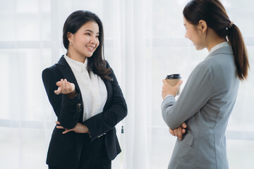 Two asian business woman work together to get the job done at the office