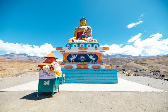 colorful and vibrant golden buddha statue in Langza Village surrounded by Himalayan Mountains in Spiti Valley
