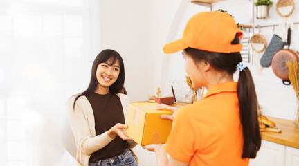 Female worker delivering parcels customer : Customer young woman standing at home picking up the...