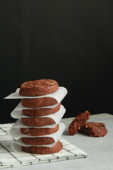 Pile of Chocolate Cookies on dark black background on a table.