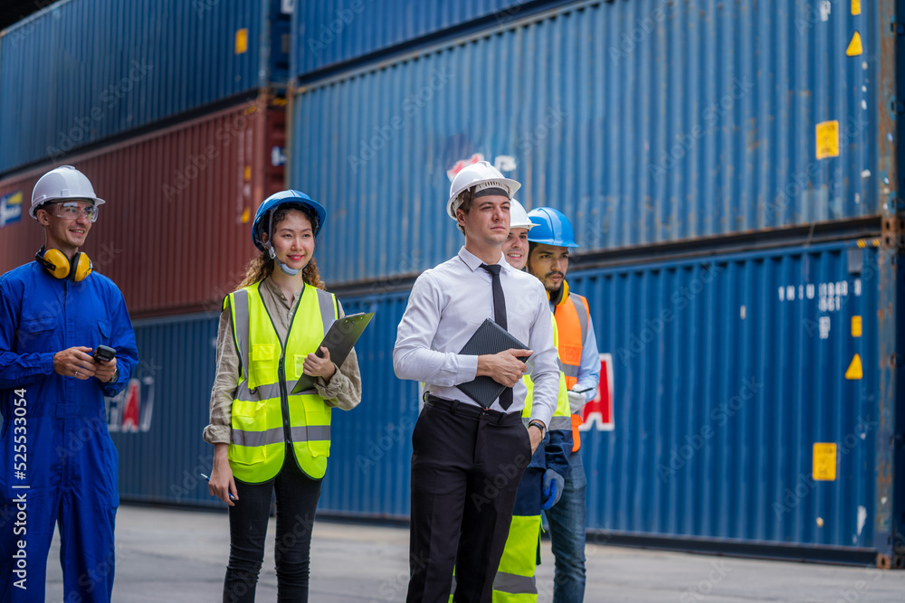 Poster Engineer and foreman team in hardhat checking stock into container for loading from cargo at container yard,Import export shipping concept.