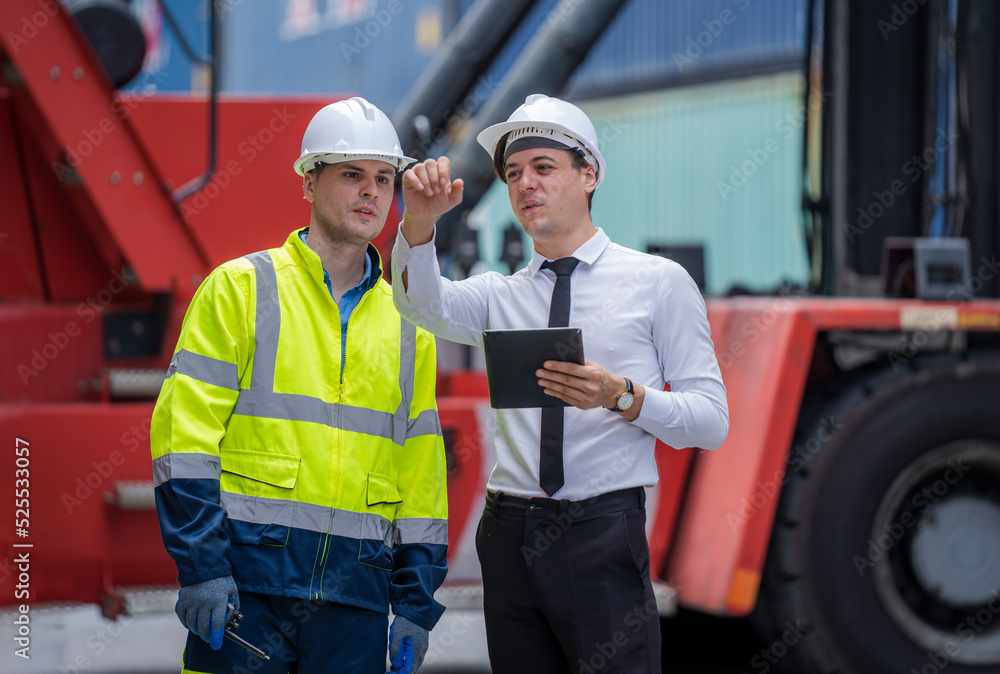 Poster Manager and worker working checking stock into container for loading,Logistic and business export.