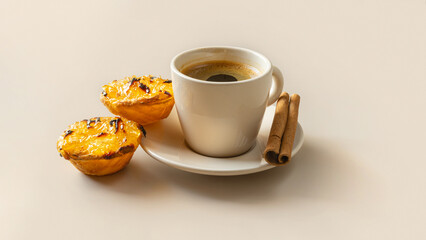 Typical Portuguese dessert pastel de chila - pastry tarts of squash with a cup of coffee on beige background