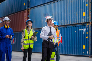 Engineer and foreman team in hardhat checking stock into container for loading from cargo at container yard,Import export shipping concept.