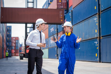 Manager and Technicians planning the transportation of goods for import Or export in the container yard,Checking on shipping containers.