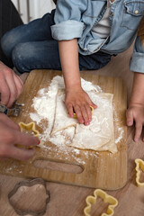 children's hands cut out cookies from dough, christmas pastries.