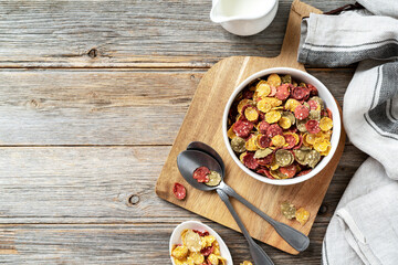 Vegetable cereal for a healthy breakfast in a white plate on a gray wooden kitchen table. Top view from the copyspace