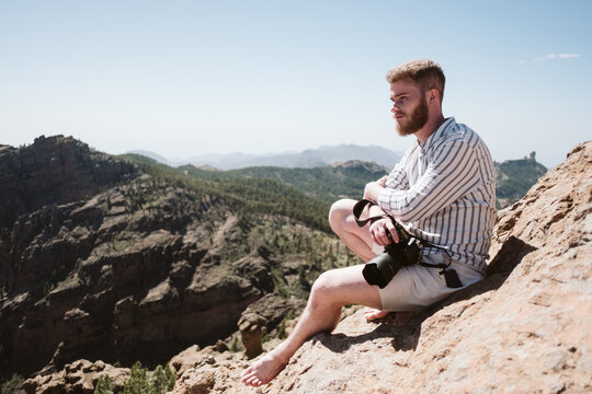 Photographer taking photos in a mountainous landscape
