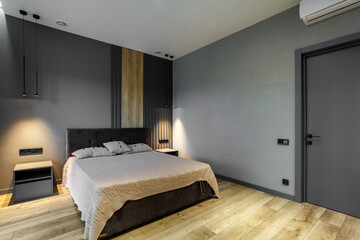 Modern and loft bedroom with dark and grey style. Dark headboard and wooden floor with glass window