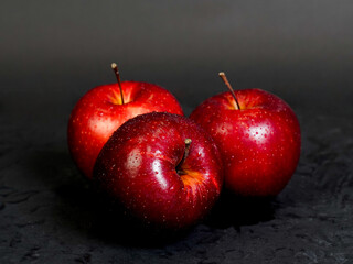 red apple on black background.