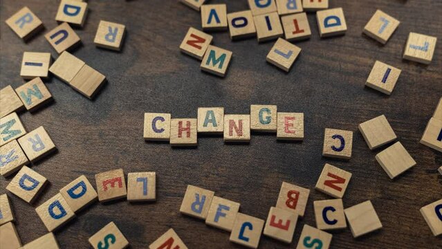 CHANGE. The need for a change represented symbolically with the use of little wooden square blocks with letters on them. High quality 4k footage