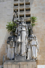 A neoclassical sculpture group of Hygieia, a Greek goddess of health, holding a rod of Asclepius, Hippocrates (left), and Galenus (right),near the Faculty of Medicine, University of Coimbra