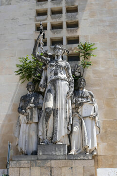 A neoclassical sculpture group of Hygieia, a Greek goddess of health, holding a rod of Asclepius, Hippocrates (left), and Galenus (right),near the Faculty of Medicine, University of Coimbra
