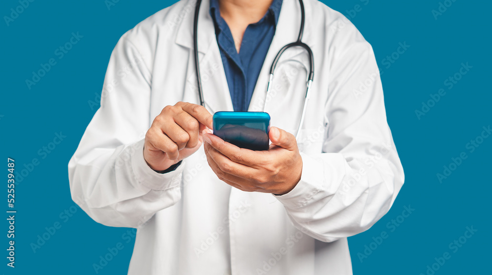 Poster doctor in a uniform with a stethoscope using a smartphone while standing on a blue background