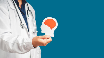 Doctor in uniform holding a white head with a red brain symbol while standing on a blue background