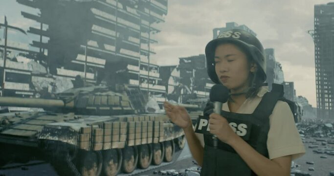 A war reporter female reporting from the ruined city on the background of a passing convoy of tanks