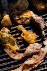 Aerial shot of grilled meat cooking on a wrought iron grill