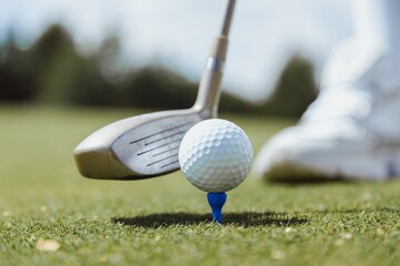 Golf ball on tee ready to start game. Golf driver before swing