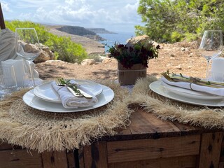 Romantic dinner overlooking the beautiful landscape and sea, on a beautifully picnic setting