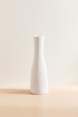 White vase isolated on wood background. Minimalist vase. Product design. Simplicity. Object....