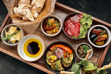 Various appetizers, snacks on a wooden board