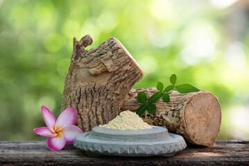 Thanaka woods ,powder and green leaves on nature background.