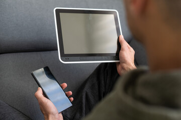 close up hands multitasking man using tablet, laptop and cellphone connecting wifi