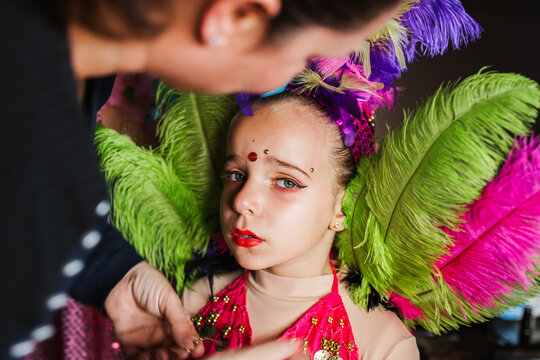Sad girl in carnival getting dressed in costume