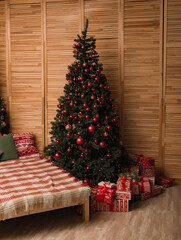 Christmas tree interior with red Christmas balls and gifts bed covered with a checkered plaid, New Year's Eve and Christmas.