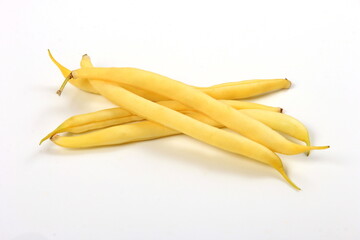 bunch of yellow butter beans on white background