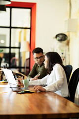 Colleagues in office. Businesswoman and businessman discussing work in office.